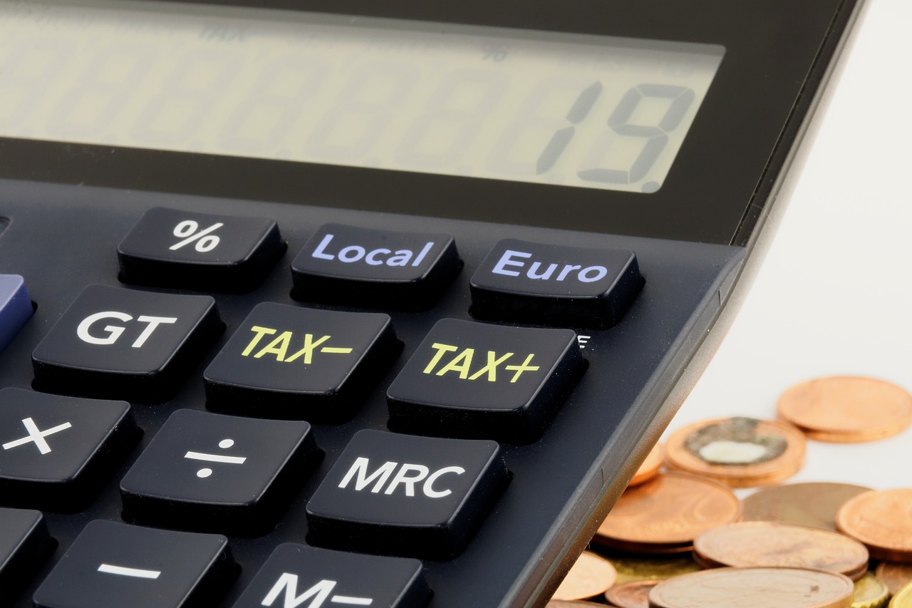 Photo showing a calculator with the word: tax.